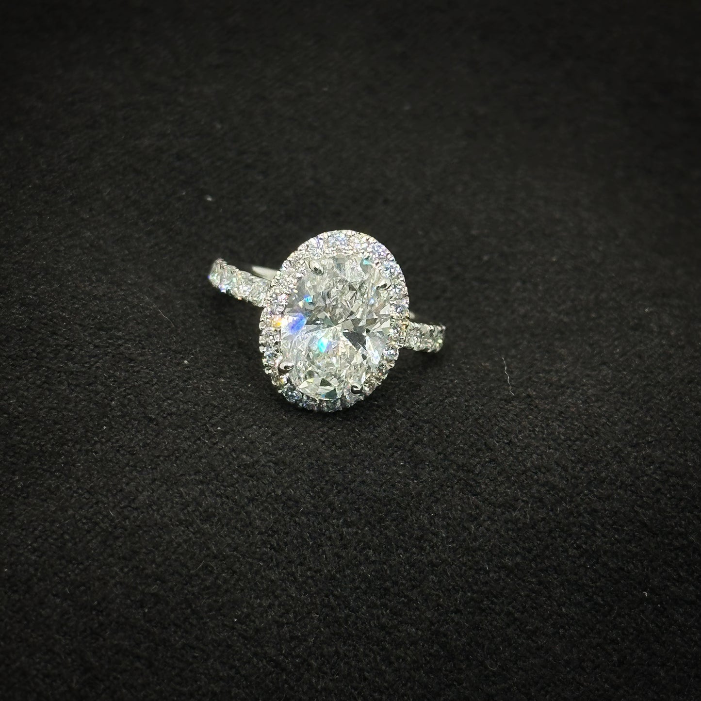 Oval with halo, half pave band