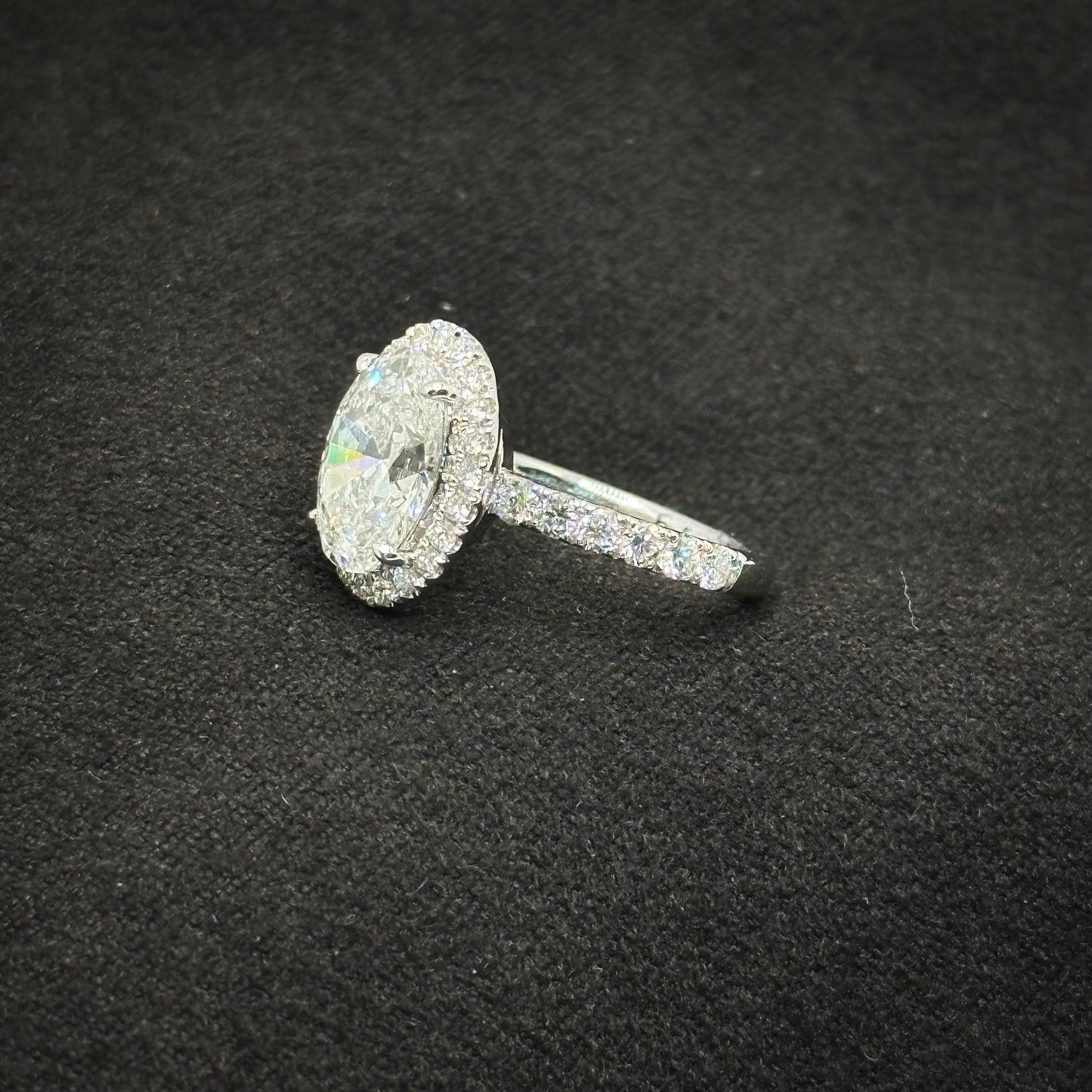 Oval with halo, half pave band
